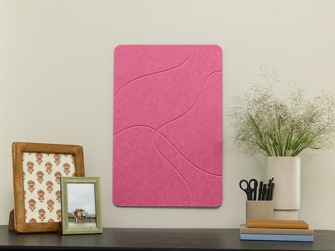 Pink acoustic panel on a wall with decorative items below