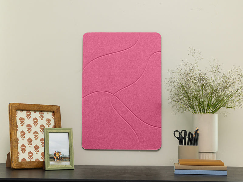 Pink acoustic panel on a wall with decorative items below