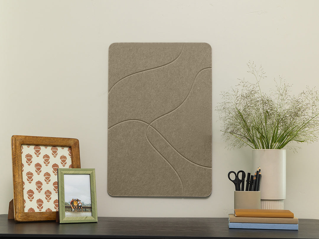 Decorative wall panel with a wooden frame, green picture frame, and plant on a shelf.