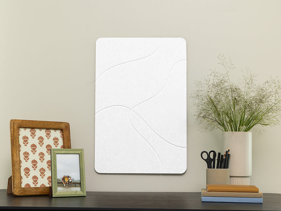 White rectangular mirror on a wooden surface with decorative items.
