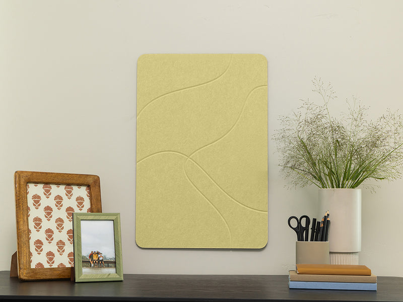 Decorative wall panel on a shelf with framed pictures and a vase.