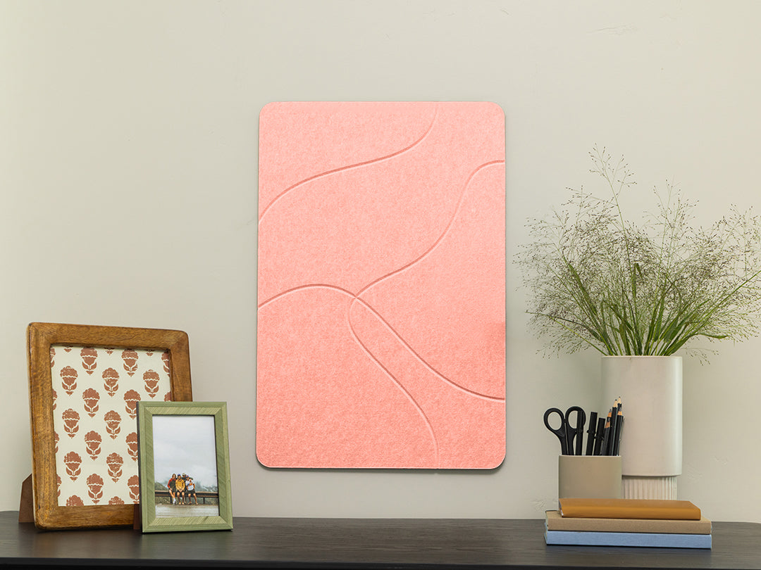 Pink wall art panel on a wall with decorative items below