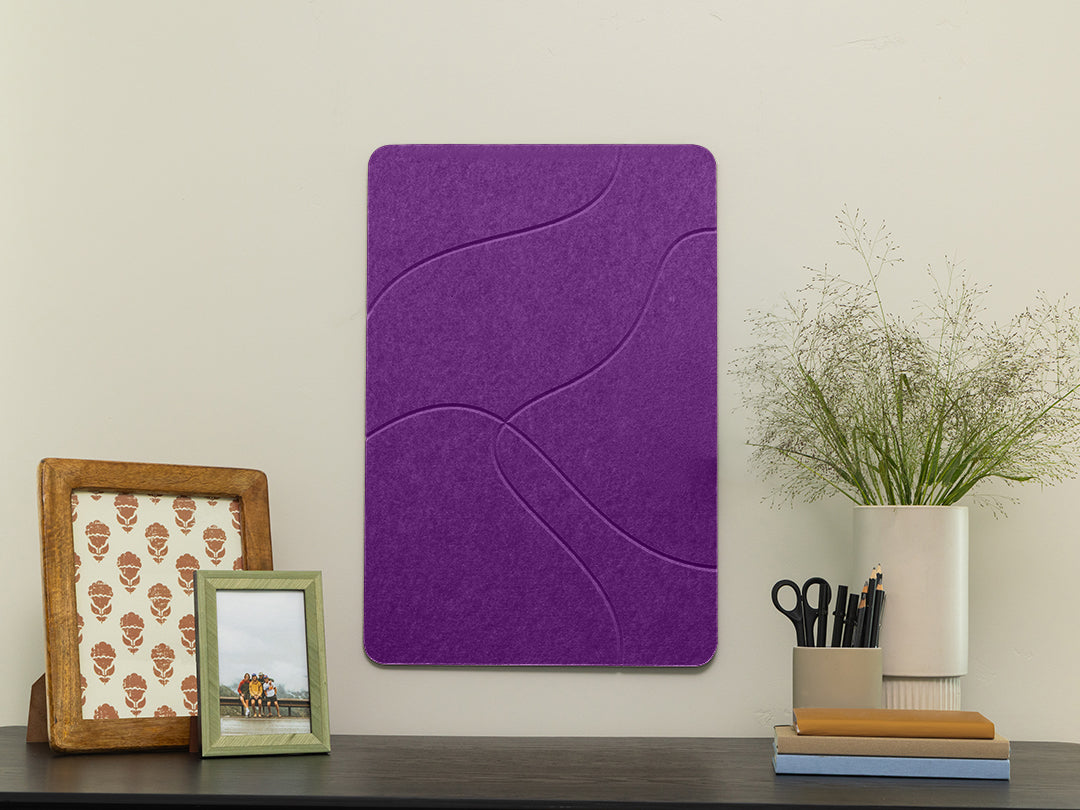 Lavender purple felt wall panel with wavy topo pattern on a shelf with decorative frames and plant