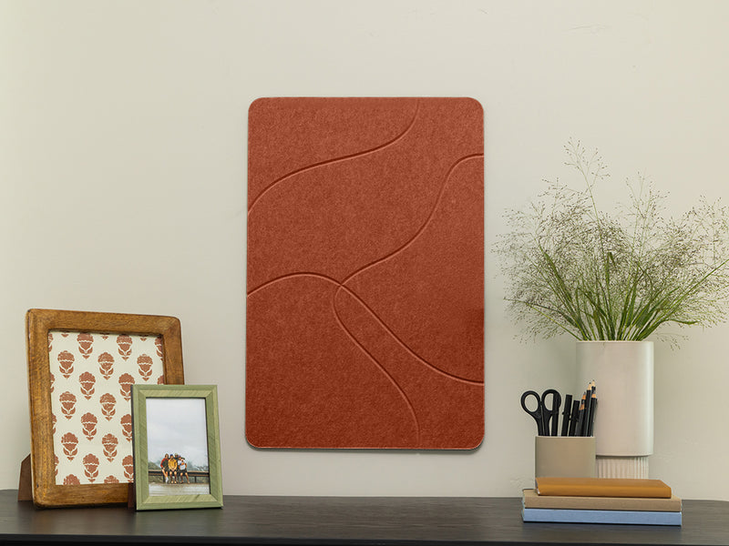Decorative wall panel with a wooden frame, green picture frame, and plant on a shelf.