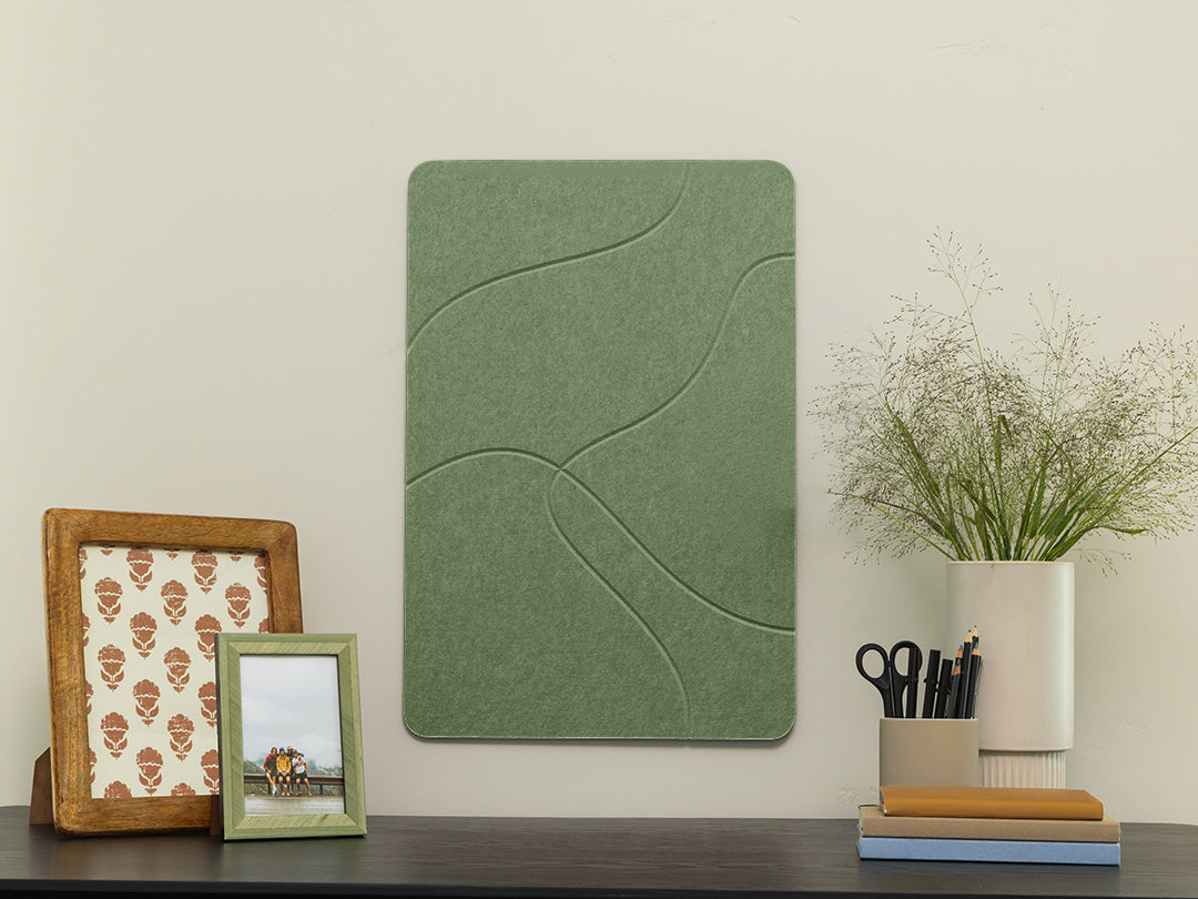 Green acoustic panel on a wall with decorative items below