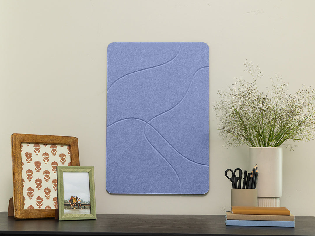 Blue acoustic panel on a wall with decorative items below