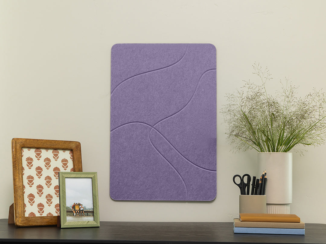 Purple wall panel on a white wall with decorative items below.