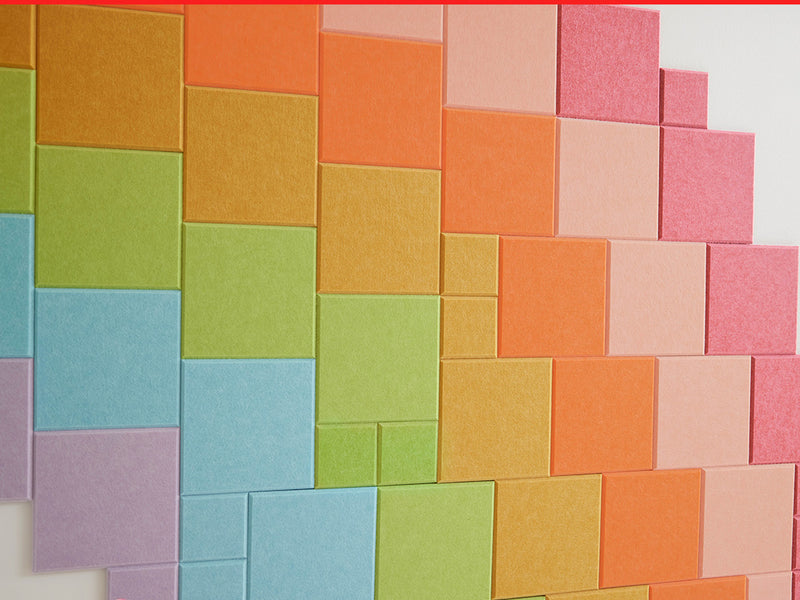Colorful square tiles arranged in a pattern on a white background