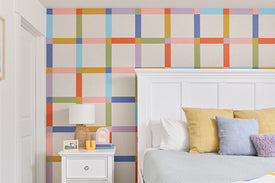 Felt Right plaid design on wall behind bed.
