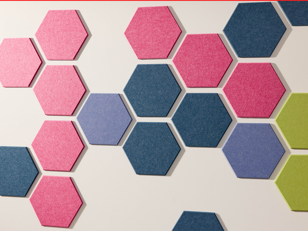 Hexagonal tiles in pink, blue, and green on a light background