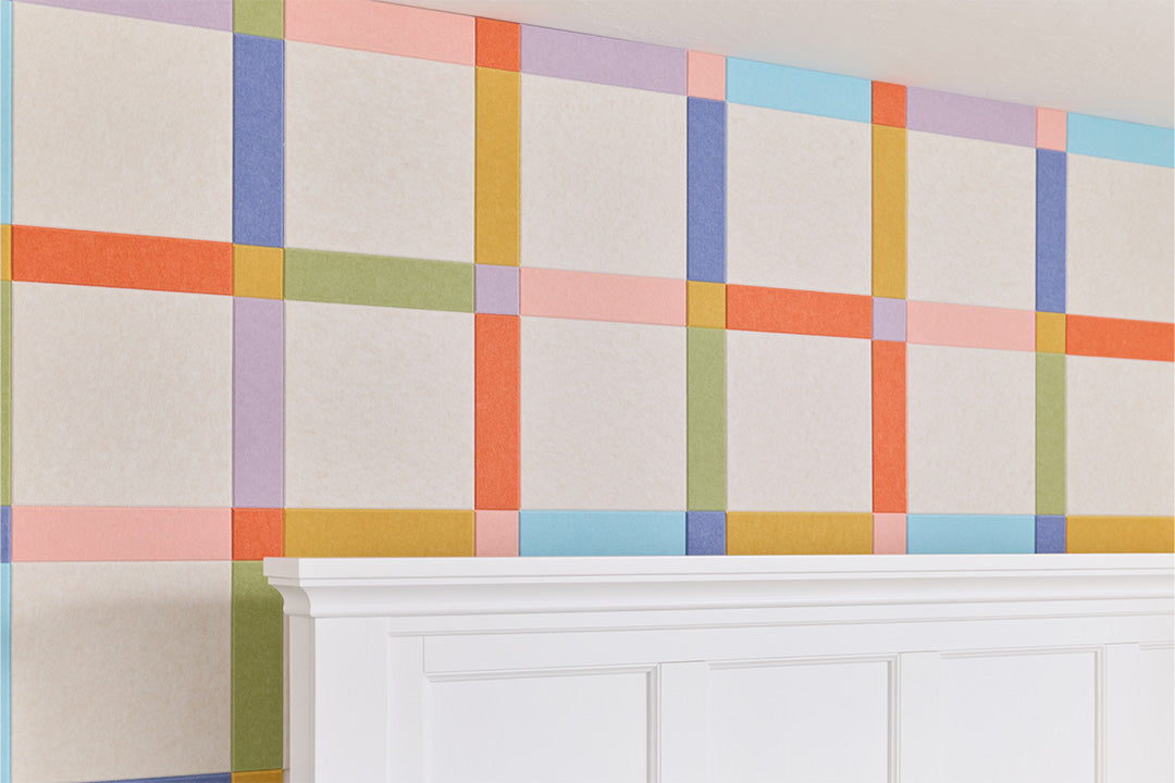 Felt Right plaid design on wall behind bed.