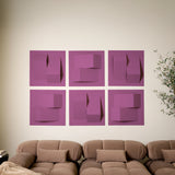Purple-pink acoustic felt tiles in a modern 3D design above a couch