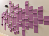 Purple dimensional tiles arranged in a staggered wall pattern with varying depths and heights.