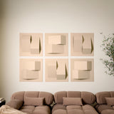 Light tan felt acoustic tiles with peak dimensions on a wall above a couch