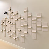 Light tan acoustic tiles made of felt on a wall with points of dimension