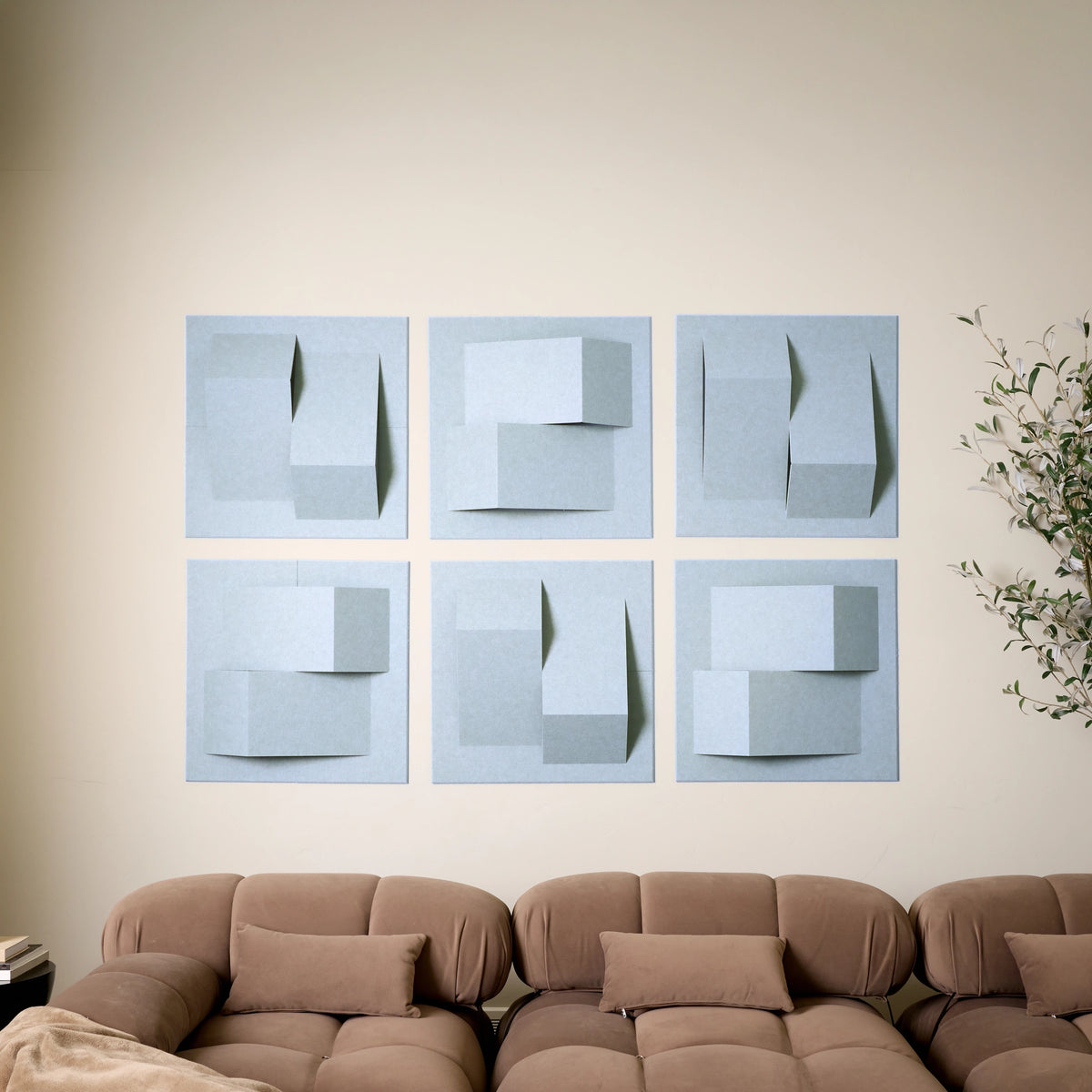 Light blue acoustic felt wall tiles with raised geometric shapes used as modern living decor