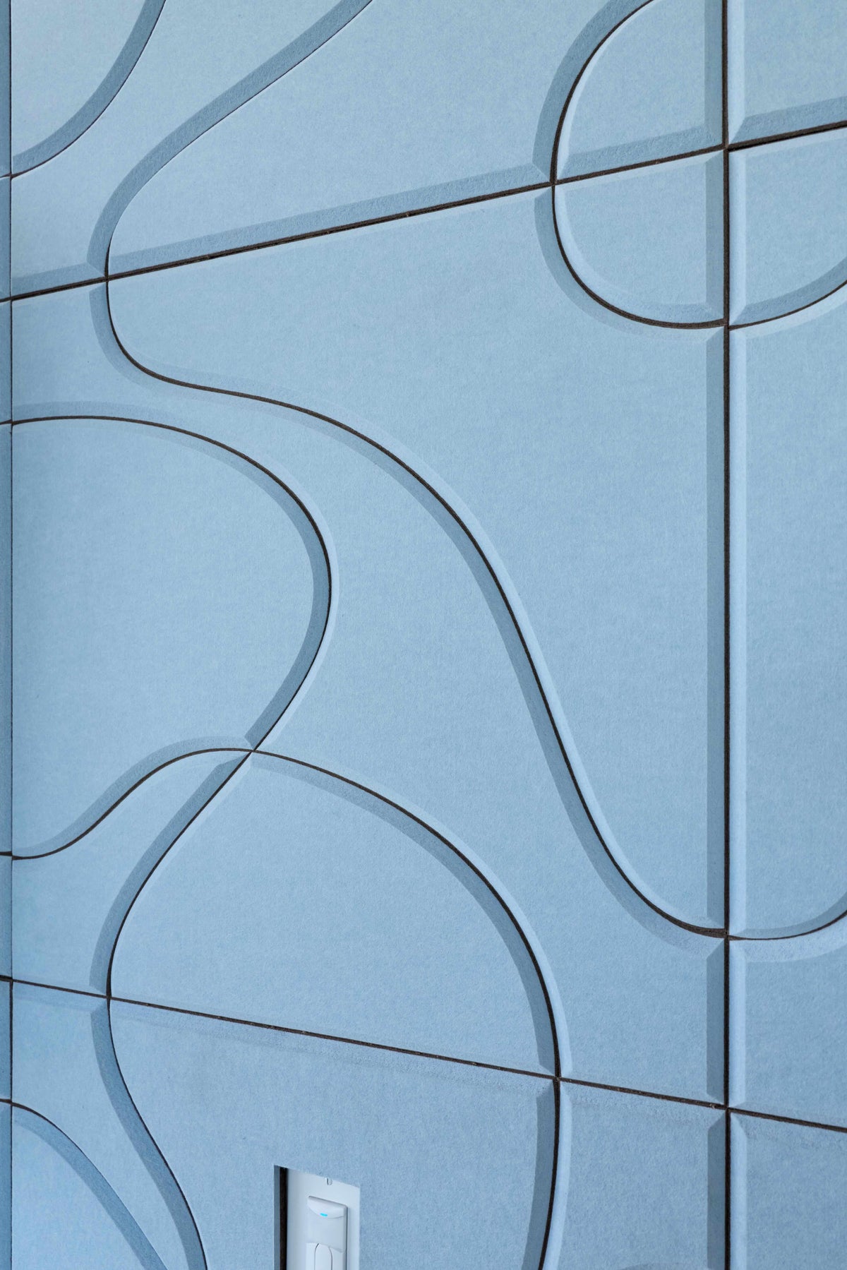 Blue tiled wall with wavy line patterns