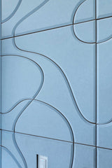 Blue tiled wall with wavy line patterns