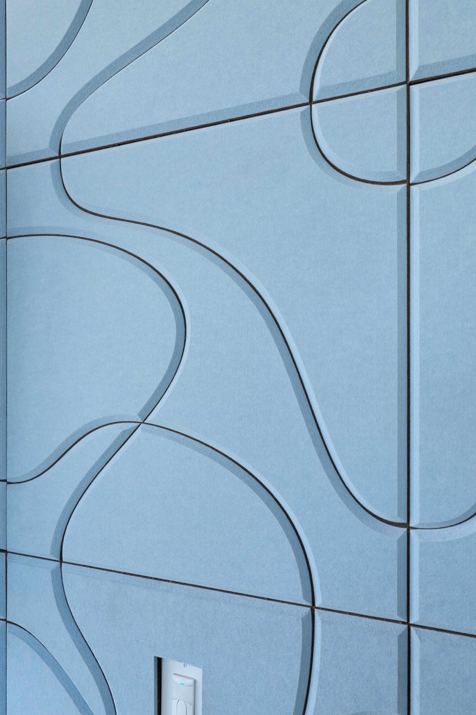 Blue tiled wall with wavy line patterns