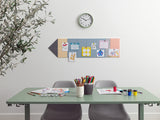 Desk with art supplies, chairs, and a wall with a clock and decorative items.