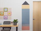 Colorful wall panels in a room with a desk and door.