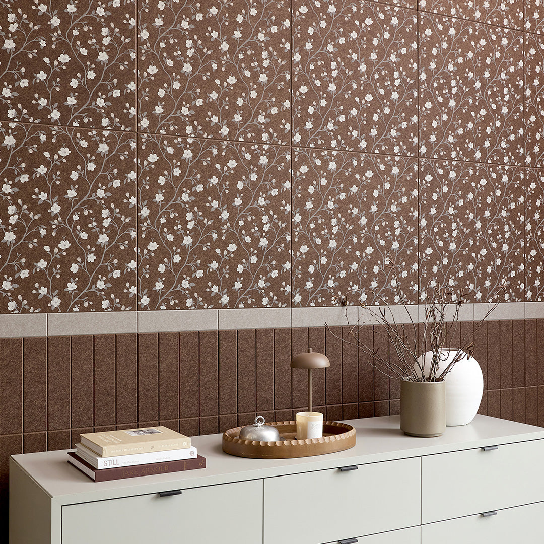 Brown ceramic tile with white flowering branches and blossoms in repeating pattern.