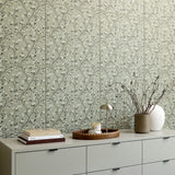 Sage green tile with delicate branching pattern of small white blossoms and dark stems arranged in repeating rows.