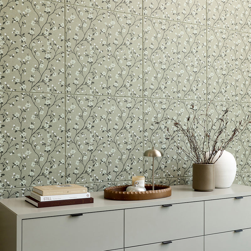 Sage green tile with delicate branching pattern of small white blossoms and dark stems arranged in repeating rows.