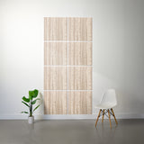 A panel canvas wall art set featuring a vertical birch tree pattern in light beige and cream, styled on a white wall in a modern room setting with a white chair and a potted plant.