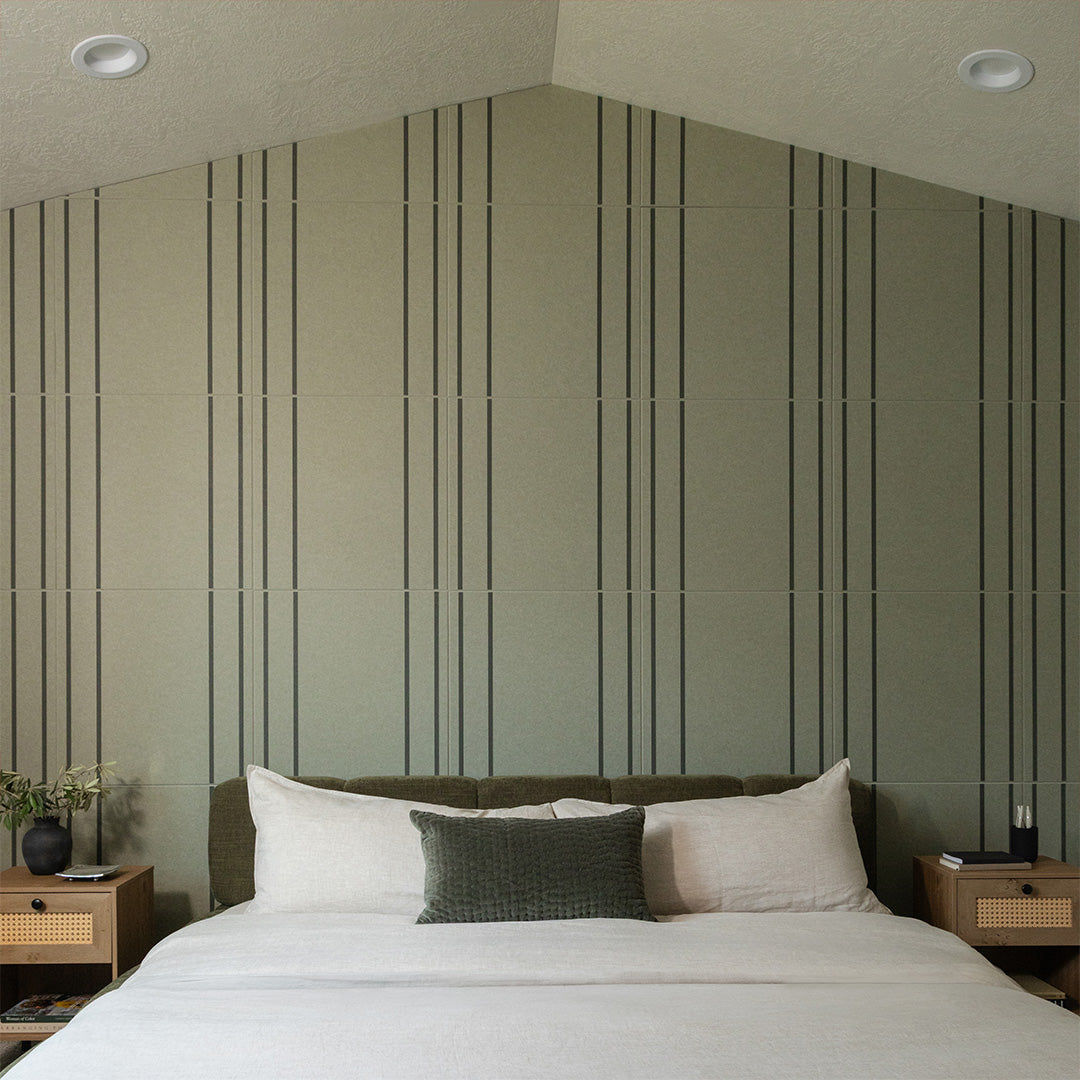 Beige tile with vertical dark pinstripes in repeating pattern, installed on bedroom wall.