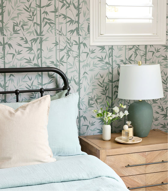 printed bamboo acoustic tiles above a comfy bed with a white bedspread