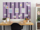 Purple bulletin board with dark pinstripes displaying various colorful papers and illustrations with push pins.