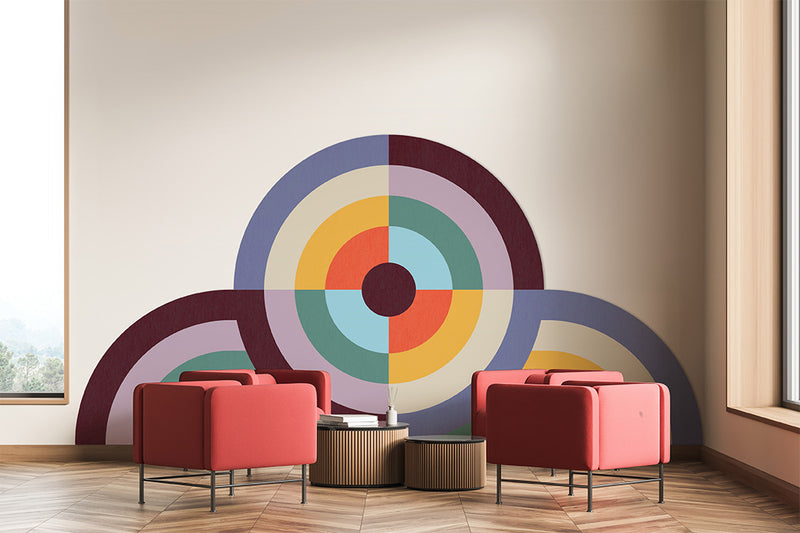 Modern waiting room with red chairs and a colorful circular wall art.