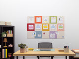 Home office setup with a desk, chair, and wall-mounted colorful calendar.