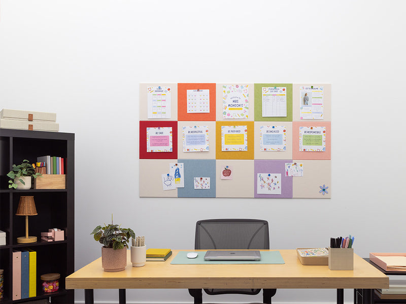 Home office setup with a desk, chair, and wall-mounted colorful calendar.