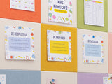 Colorful bulletin board with educational posters on a grid patterned wall.