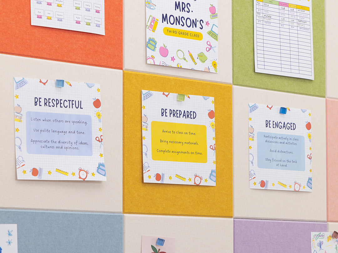 Colorful bulletin board with educational posters on a grid patterned wall.