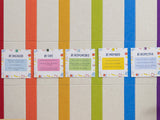 Bulletin board with vertical rainbow pinstripes and five removable cards displaying classroom behavior expectations.