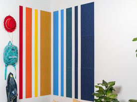 Rainbow felt wall tiles in corner with kids decor.