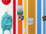 Rainbow wall tiles with photos pinned up.
