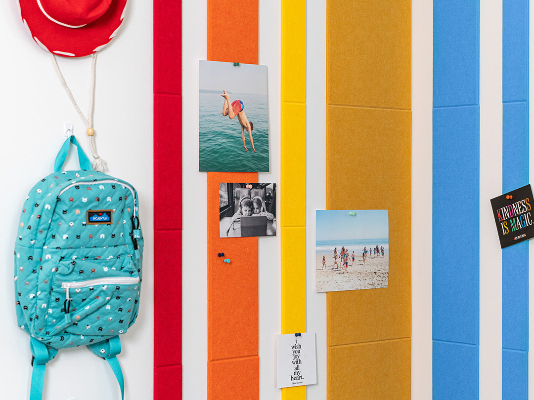Rainbow wall tiles with photos pinned up.