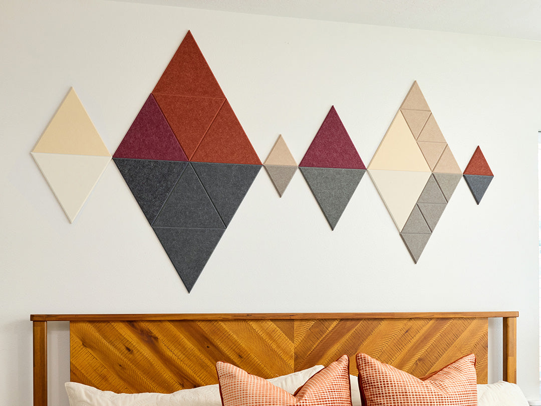 Acoustic wall art in triangles above bed