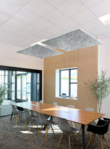 Modern conference room with a long wooden table, gray and black chairs, a slatted wood accent wall, large windows, and two rectangular gray acoustic ceiling panels.