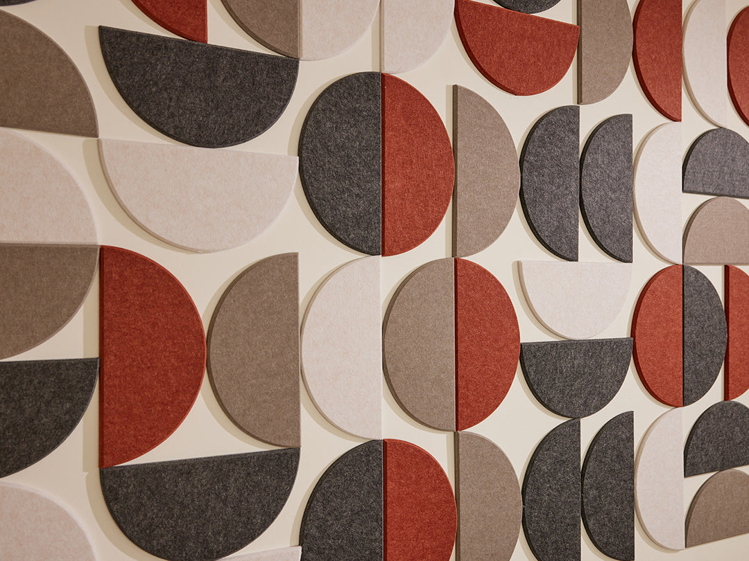 Patterned wall covering with geometric shapes in red, gray, and beige.
