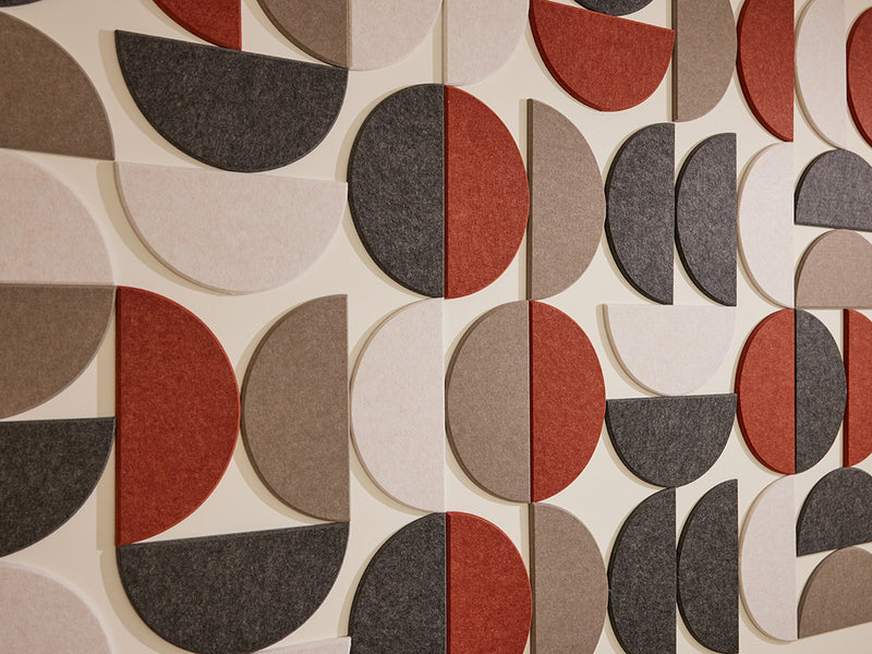 Patterned wall covering with geometric shapes in red, gray, and beige.