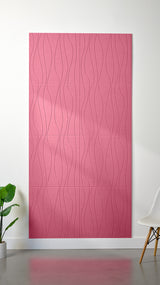 Hot pink Felt Right 4’ x 8’ PET felt panel with flowing lines engraved into the material against a white wall. A plant and chair are in the foreground.