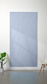 Light blue felt sheet with wavy line engraving pattern displayed on wall.
