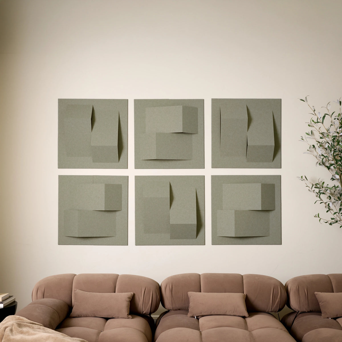 Soft green sound absorbing felt all tiles in a geometric  pattern above a living room sofa