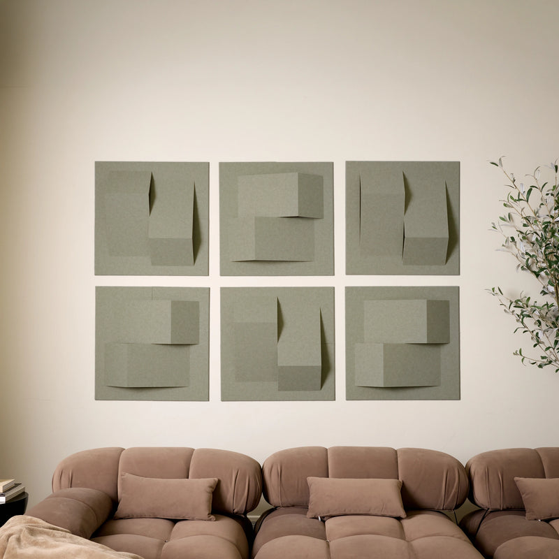 Soft green sound absorbing felt all tiles in a geometric  pattern above a living room sofa