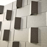 Sage green 3D acoustic wall panels featuring a modern geometric design on a wall.